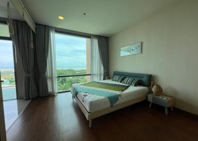 Modern bedroom with a large window and scenic view