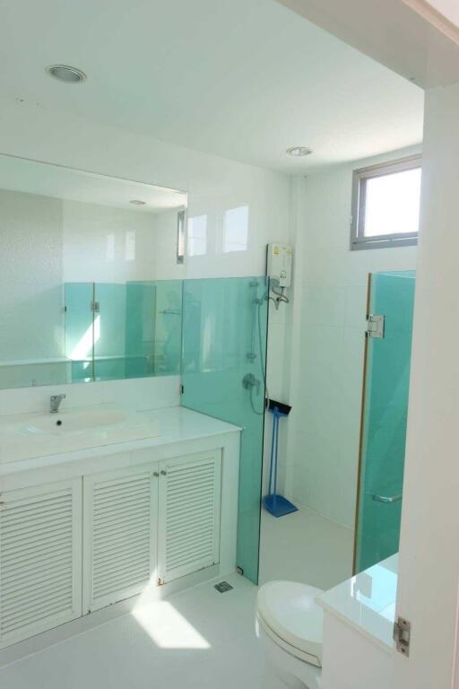 Modern bathroom with glass shower and white vanity