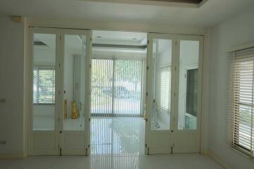 Spacious living area with glass doors and ample natural light