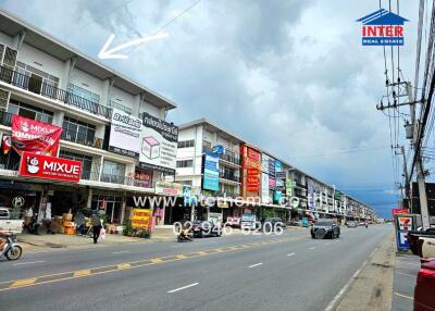 Street view of commercial buildings with signs and advertisements