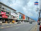 Street view of commercial buildings with signs and advertisements