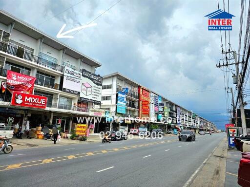 Street view of commercial buildings with signs and advertisements