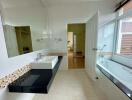 Modern bathroom with large mirror, sink, and bathtub