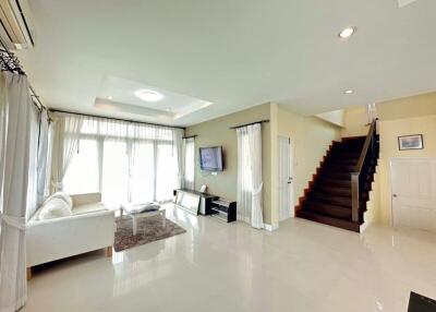 Spacious living room with modern furniture and a staircase