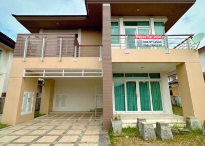 Two-storey house for rent with a paved driveway, balcony, and front lawn