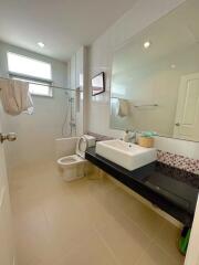 Modern bathroom with shower, sink, and toilet