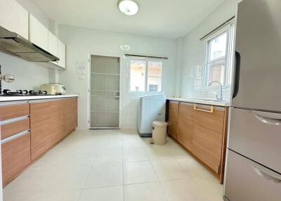 Modern kitchen with stainless steel appliances and wooden cabinets