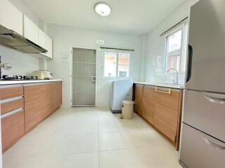 Modern kitchen with stainless steel appliances and wooden cabinets