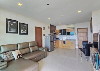 Spacious living room with modern decor and adjacent kitchen area