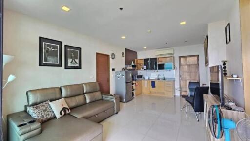 Spacious living room with modern decor and adjacent kitchen area