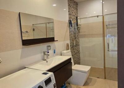 Modern bathroom with washing machine and shower