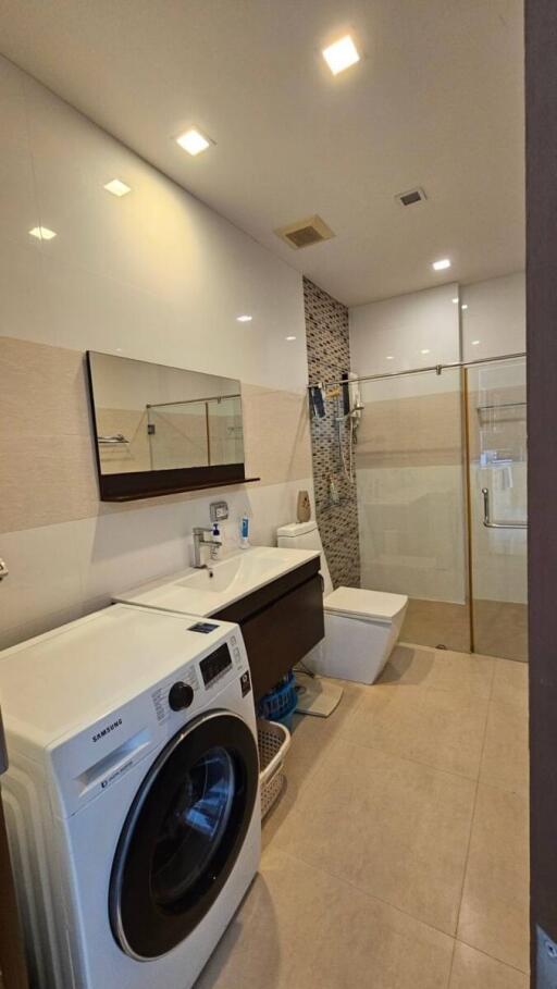 Modern bathroom with washing machine and shower