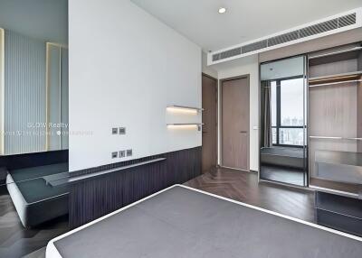 Modern bedroom with large mirrors, built-in shelves, window view, and a minimalist design.