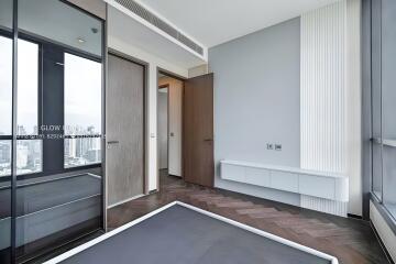 Modern bedroom with large windows and city view