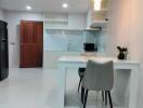 Modern kitchen with white cabinetry and a dining area