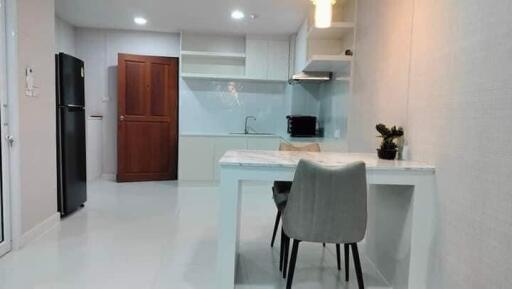 Modern kitchen with white cabinetry and a dining area