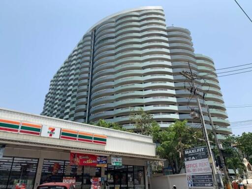 Modern multi-story apartment building with nearby convenience store