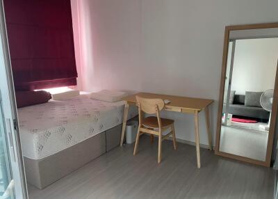 Bedroom with bed, study desk, chair, and a full-length mirror