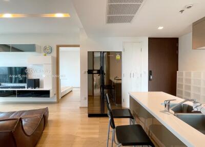 Modern kitchen with bar seating and adjacent living area