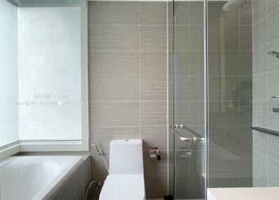 Modern bathroom with bathtub and glass-enclosed shower