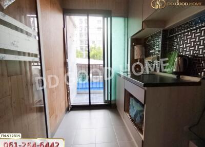 Compact modern kitchen with sliding door access to balcony