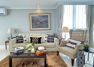 Cozy and well-decorated living room with a sofa, armchair, coffee table, and wall art.