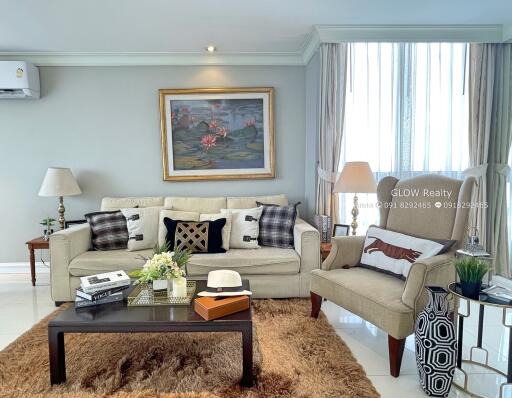 Cozy and well-decorated living room with a sofa, armchair, coffee table, and wall art.