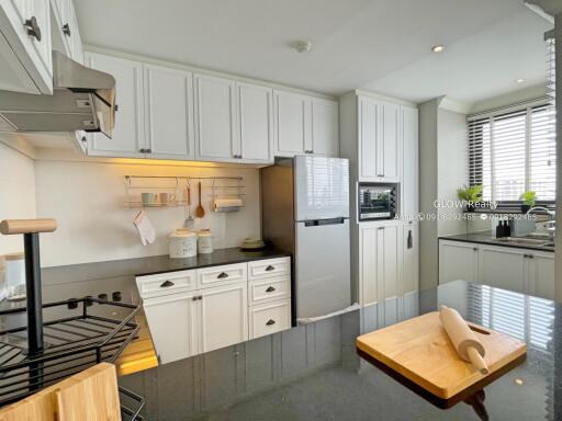 Modern kitchen with white cabinetry and stainless steel appliances