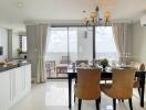 Modern kitchen and dining area with a view of a balcony