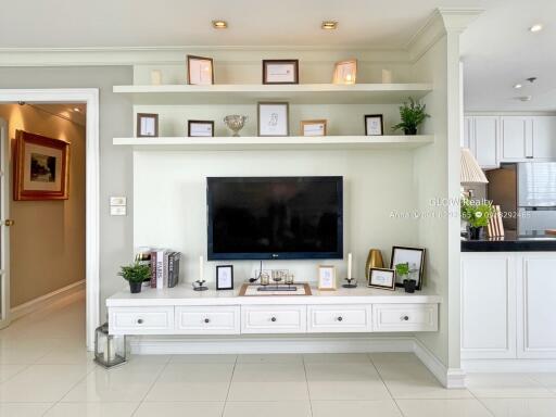 Living room with built-in TV unit and decorative shelves