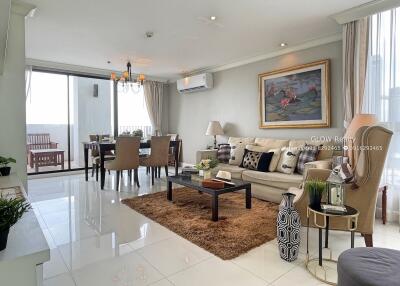Modern and spacious living room with dining area and balcony access