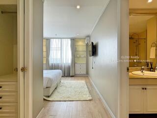 Bright bedroom with cream walls and wooden floors