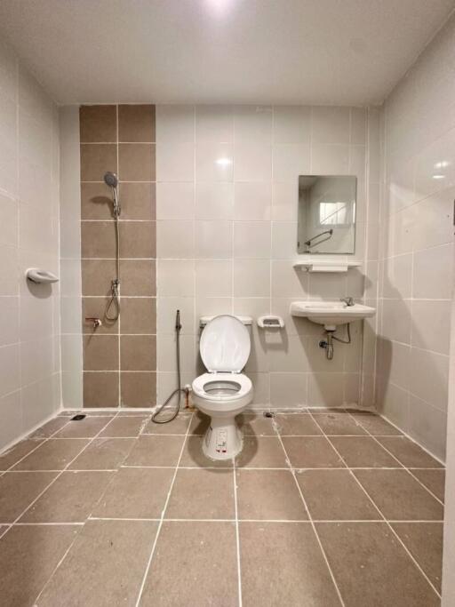 Spacious bathroom with shower and toilet