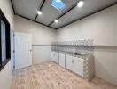 Modern kitchen with checkered backsplash, sink, and white cabinets