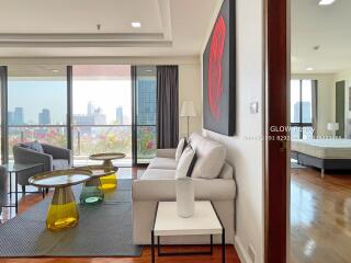 Modern living room with large windows and city view