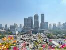 City skyline view from balcony with flowers in the foreground