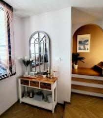 Bright living area with decorative console table and mirror