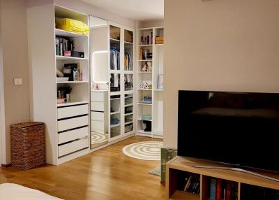 Bedroom with walk-in closet and entertainment center