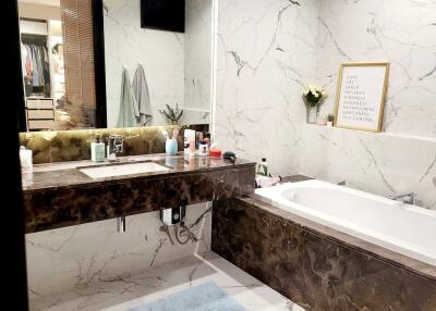 Modern bathroom with marble walls and bathtub