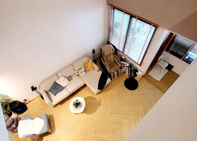 Aerial view of a cozy living room with furniture and large windows