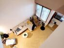 Aerial view of a cozy living room with furniture and large windows