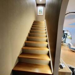 Modern staircase with wooden steps and LED lighting