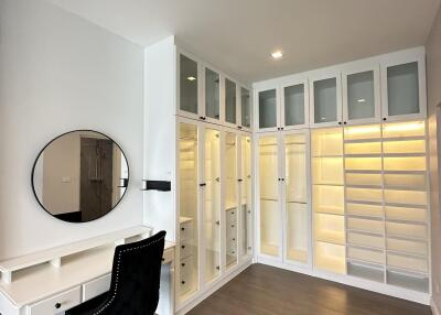 Spacious walk-in closet with a vanity and ample storage