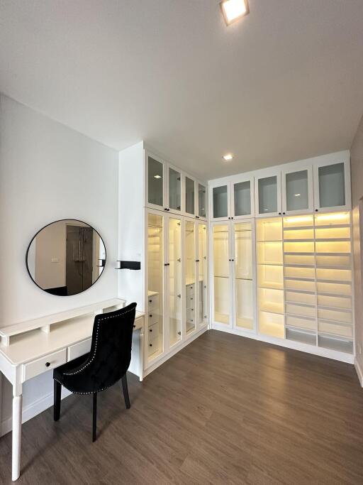 Spacious walk-in closet with a vanity and ample storage