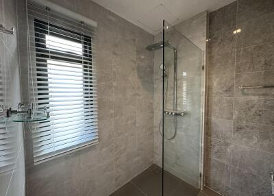 Modern bathroom with glass shower and large window