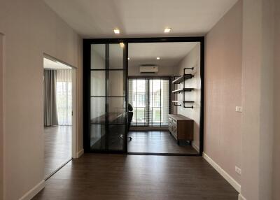 Modern home office with large glass doors and wooden flooring