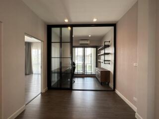 Modern home office with large glass doors and wooden flooring