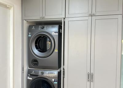 Laundry room with stacked washer and dryer