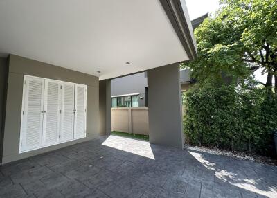 Outdoor area with tiled flooring and greenery