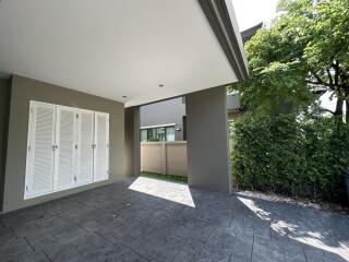 Outdoor area with tiled flooring and greenery